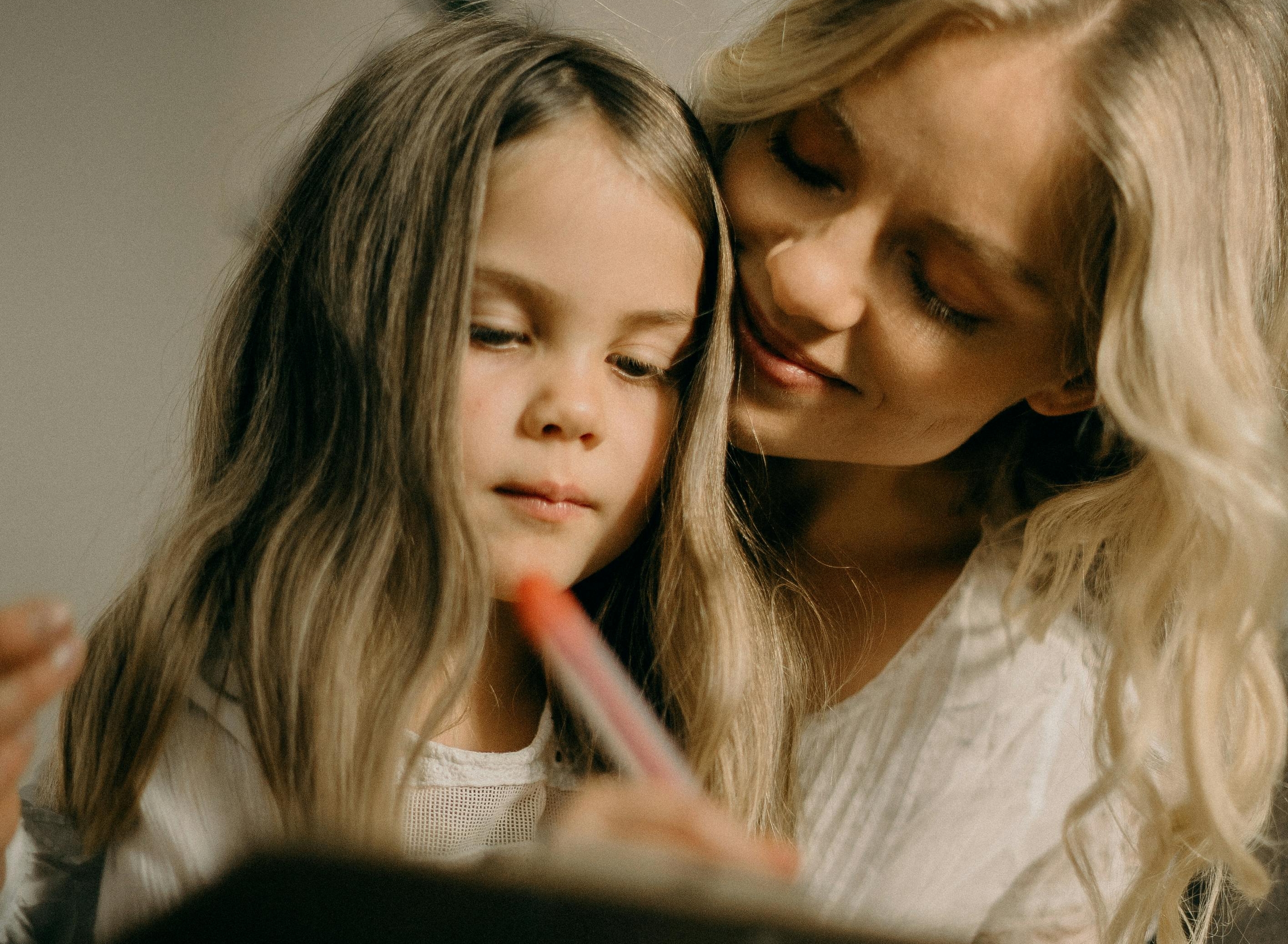 Horizontal photo of mother and daughter working together